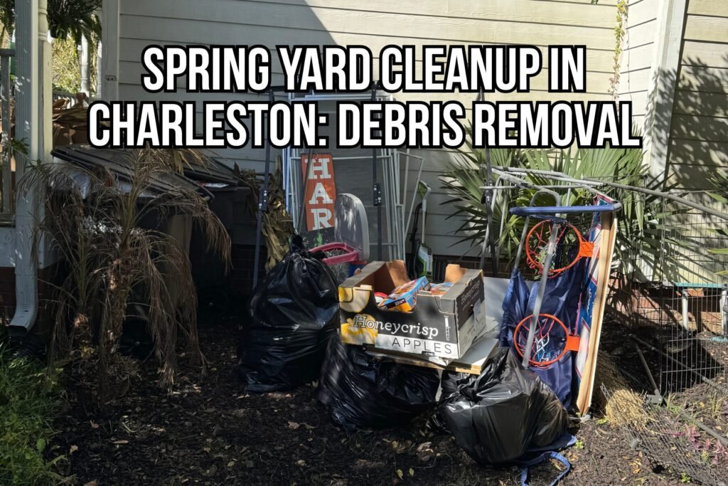 Spring yard cleanup Charleston showing piled debris and junk removal items, including black trash bags, yard waste, a basketball hoop, and miscellaneous outdoor clutter beside a home.