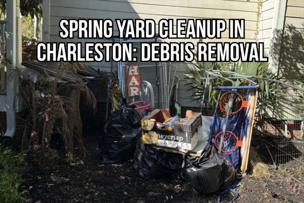 Spring yard cleanup Charleston showing piled debris and junk removal items, including black trash bags, yard waste, a basketball hoop, and miscellaneous outdoor clutter beside a home.
