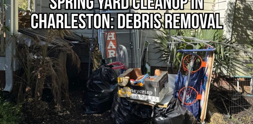 Spring yard cleanup Charleston showing piled debris and junk removal items, including black trash bags, yard waste, a basketball hoop, and miscellaneous outdoor clutter beside a home.
